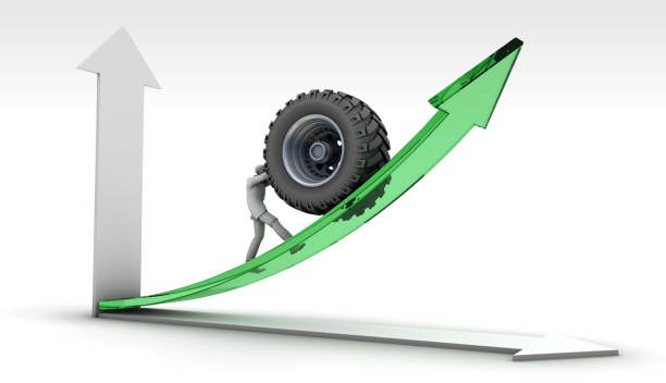 An entrepreneur trying to increase his market share by pushing a giant tire in the rising and falling automotive industry graph. Initiatives to reduce the rising carbon footprint in the automotive industry and variable profit realization graph. / You can see the animation movie of this image from my iStock video portfolio. Video number: 2167715102